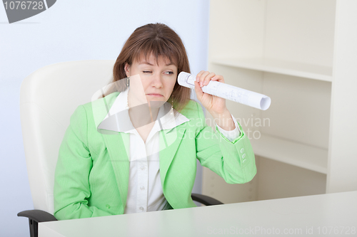 Image of Ridiculous woman looks through drawing curtailed by tubule