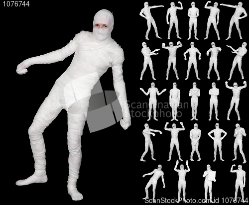 Image of Collection of terrible bandaged mummies isolated on black backgr