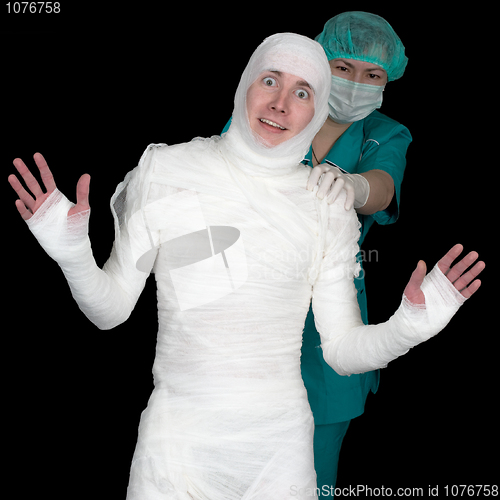 Image of Funny sick in bandage and nurse on black background