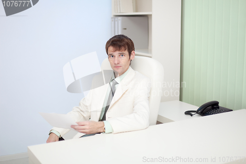 Image of Young person sits at office on workplace
