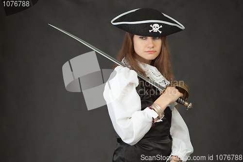 Image of Portrait of sad girl in costume of pirate with sabre