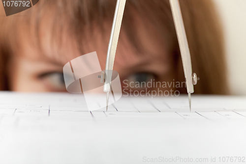 Image of Compasses and drawing close up on face background