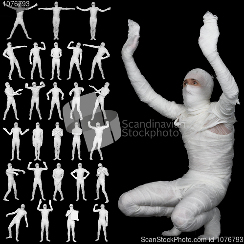 Image of Collection of bandaged mummies isolated on black background