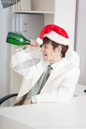 Image of Businessman celebrates Christmases at office on workplace