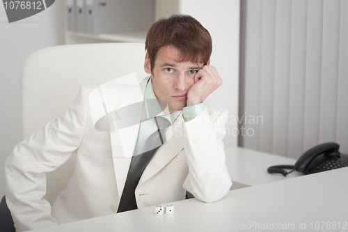 Image of Young businessman misses on workplace at office