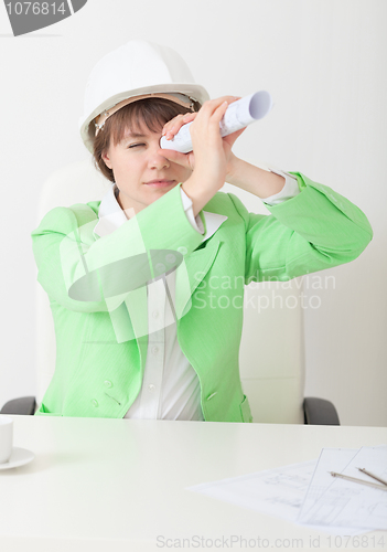 Image of Girl in helmet looks afar through drawing