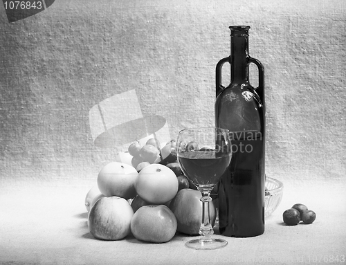 Image of Black and white still-life with wine and fruit on sacking