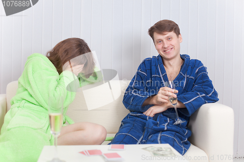 Image of Girl has lost to the man at a card play and cries