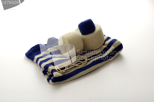Image of Blue and white striped knitting with clews