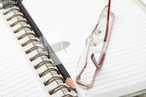 Image of Diary, pencil and glasses