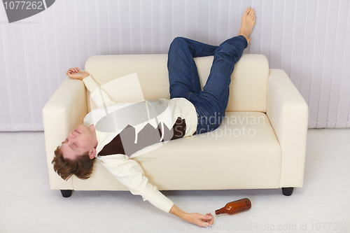 Image of Drunk person funny sleeps on sofa