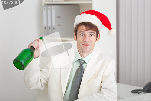 Image of Young businessman in white jacket celebrates Christmas