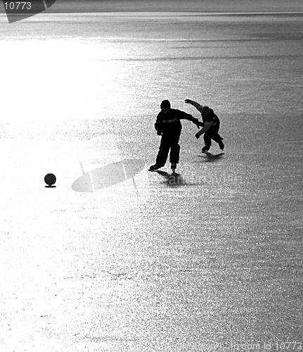 Image of 2 Ice-skating boys with a ball I