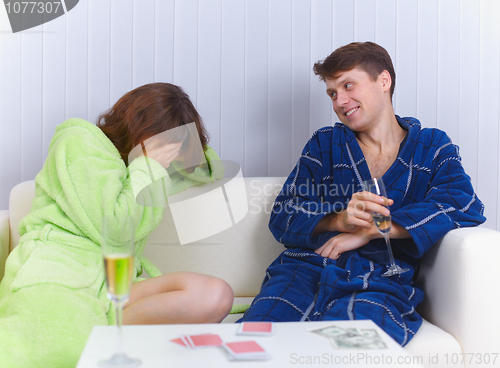 Image of Woman has lost in cards to man and cries