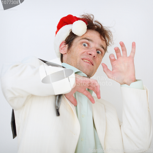 Image of Portrait of scared person in a New Year hat