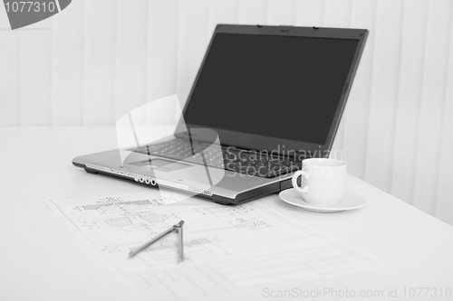 Image of Desktop of engineer with the laptop and drawing on paper