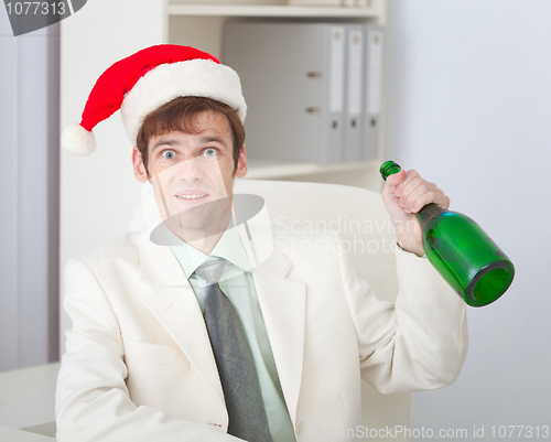 Image of Businessman cheerfully celebrates Christmas at office