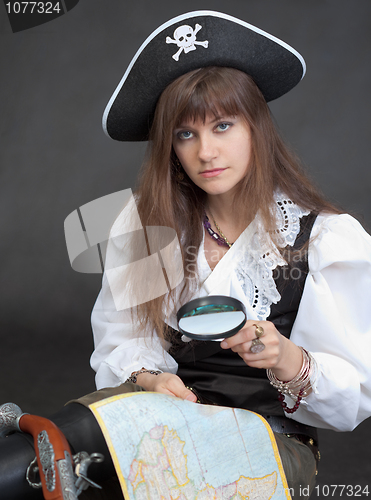 Image of Woman - sea pirate with a map and magnifier