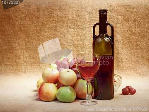 Image of Wine and fruit against brown sacking