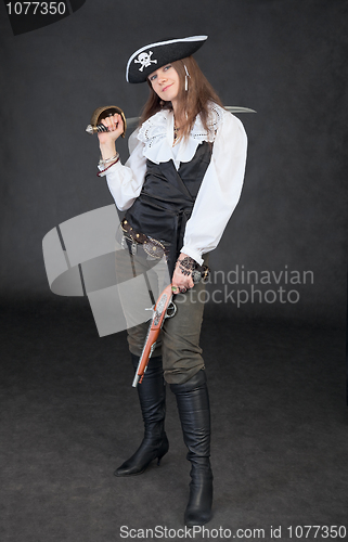 Image of Young girl in costume of sea pirate with sabre and pistol
