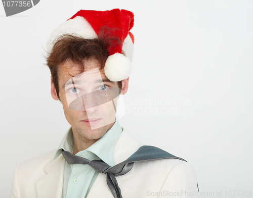 Image of Portrait of young man in Christmas cap on white background
