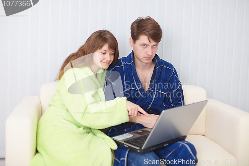 Image of Couple on sofa with laptop