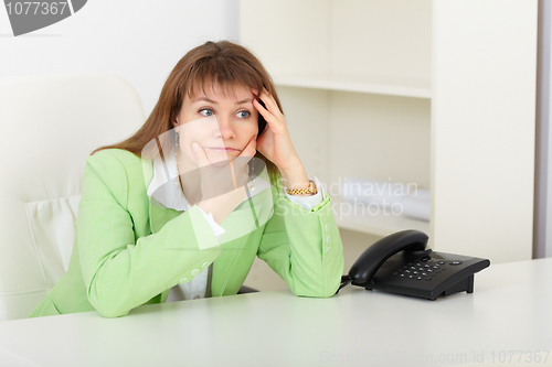 Image of Young woman with concentration thinks on workplace