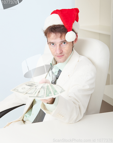 Image of Person in Christmas hat gives us money