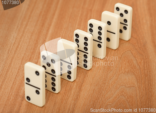 Image of line from seven dominoes on wooden surface