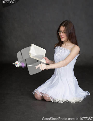 Image of Girl - fairy with magic wand and book in hands