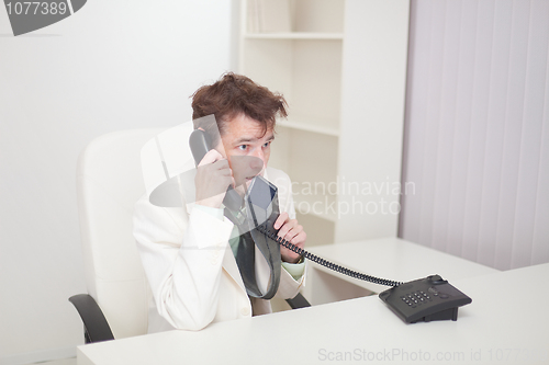 Image of Guy worries speaking by phone with chief