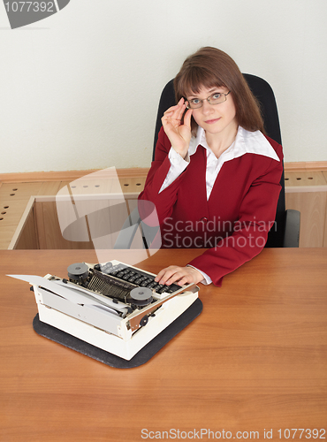 Image of Woman working with old typewriter