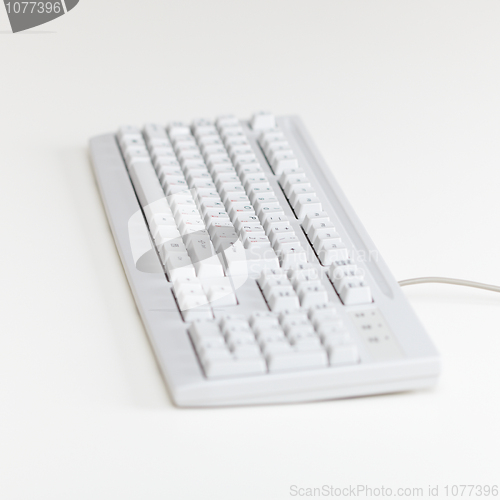 Image of Computer keyboard lies on table surface