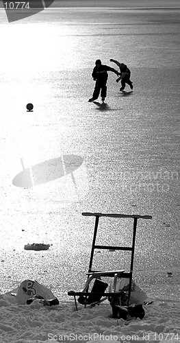 Image of 2 Ice-skating boys with a ball II