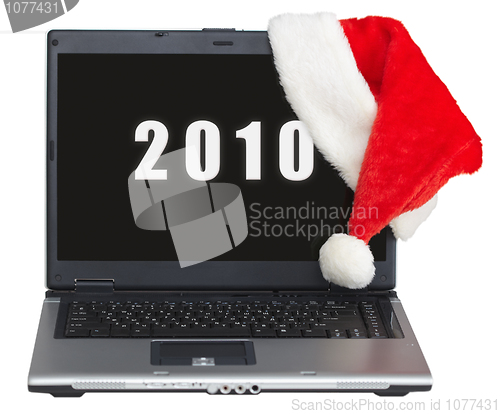 Image of New Year s laptop with 2010 on screen and santa cap