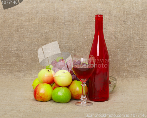 Image of Still-life - bottle and fruit against a canvas