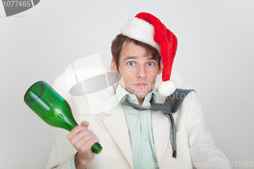 Image of Drunk businessman has dressed Christmas cap