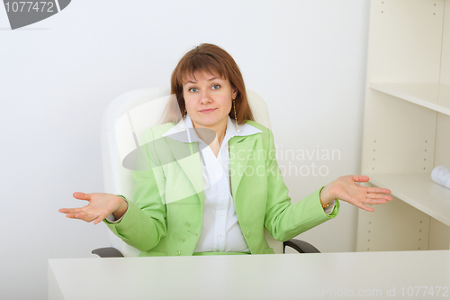Image of Surprised businesswoman shrugs