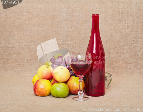 Image of Still-life - red bottle and fruit against a canvas