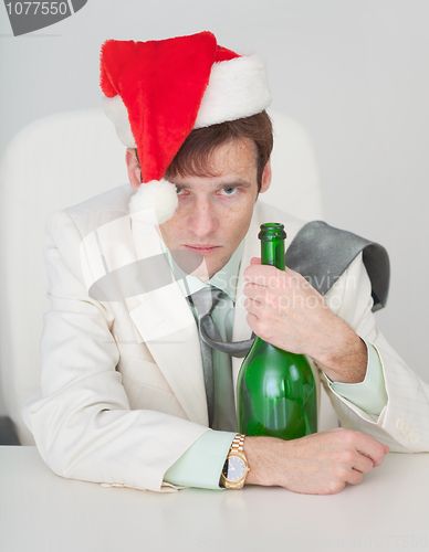 Image of Guy in Christmas cap with a bottle in hand