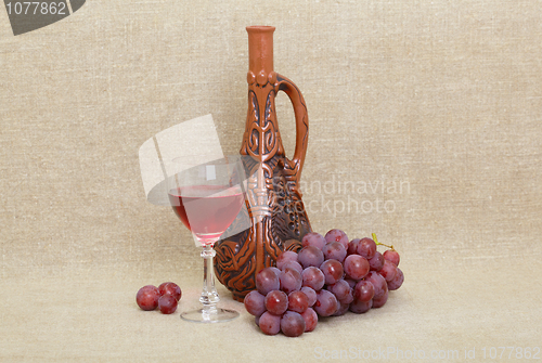 Image of Composition from clay Georgian bottle, glass and grapes