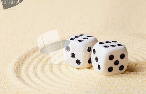 Image of Dices on sand in rock garden