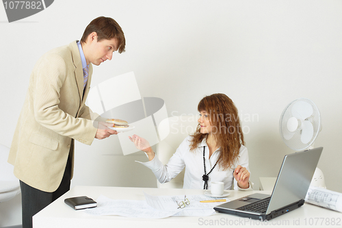 Image of Person gives to young woman meal on a plate