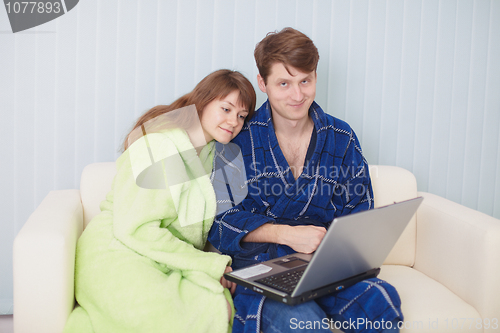 Image of Young couple on couch with laptop
