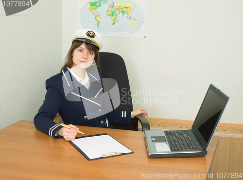 Image of Woman in uniform of sea captain at travel company office