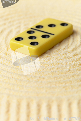 Image of Domino on yellow sand - art miniature