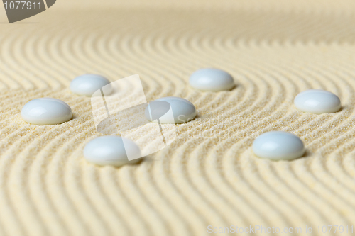 Image of White drops on surface of yellow sand - abstract composition