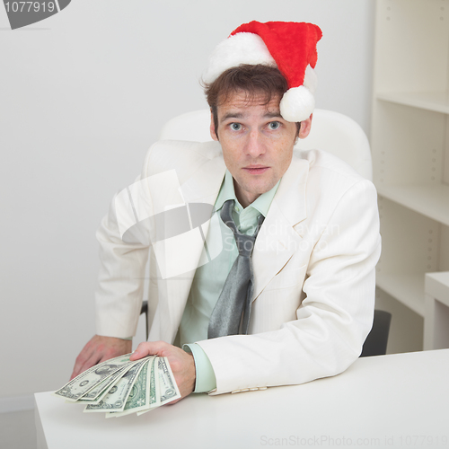 Image of Young man with christmas hat and premium