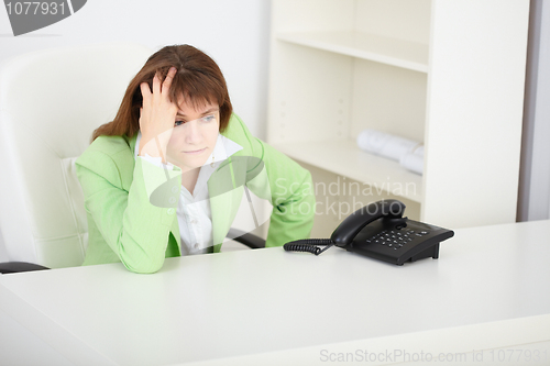Image of Sad girl secretary waits for phone call