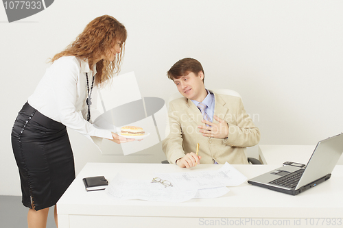 Image of Young woman delivered to chief a sandwich to dinner